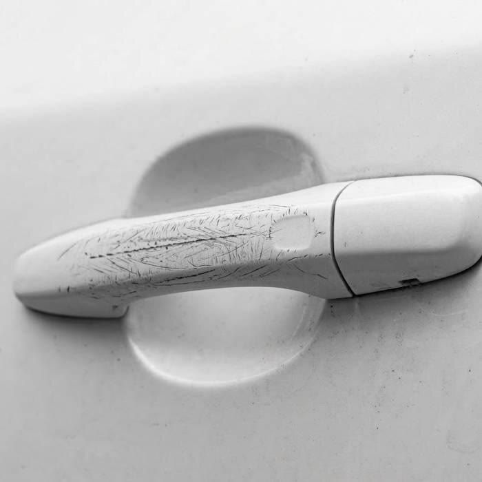 Car door handle area with light fingernail scratches